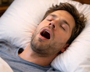 man snoring while asleep